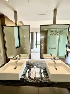 a bathroom with two sinks and two mirrors at D'Majestic by Lush Living in Kuala Lumpur