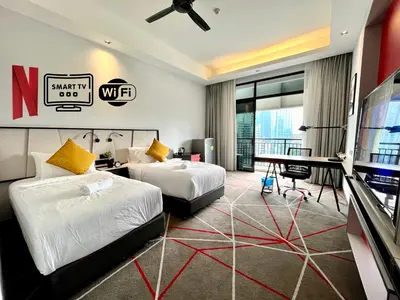 a hotel room with two beds and a desk at #173 M101 Dang Wangi KLCC View Pool By Livin in Kuala Lumpur