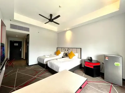 a hotel room with two beds and a ceiling fan at #173 M101 Dang Wangi KLCC View Pool By Livin in Kuala Lumpur