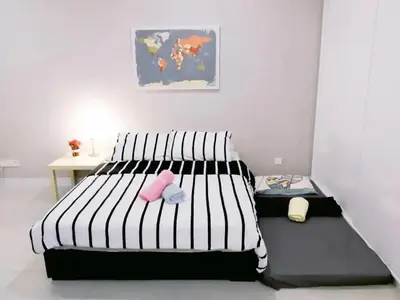 a bedroom with a black and white bed and a table at Stylish & Cozy TTDI Ascencia Studio FREE Parking in Kuala Lumpur