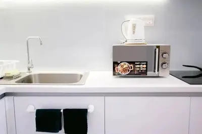 a kitchen counter with a sink and a microwave at Stylish & Cozy TTDI Ascencia Studio FREE Parking in Kuala Lumpur