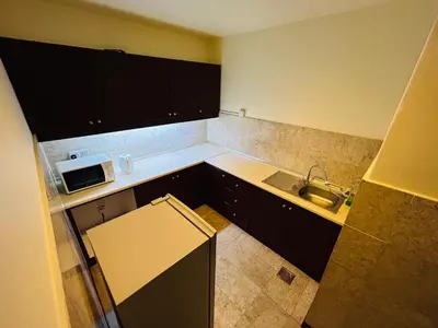 a small kitchen with a sink and a microwave at TWO BEDROOM SUITES at TIMES SQUARE KL in Kuala Lumpur