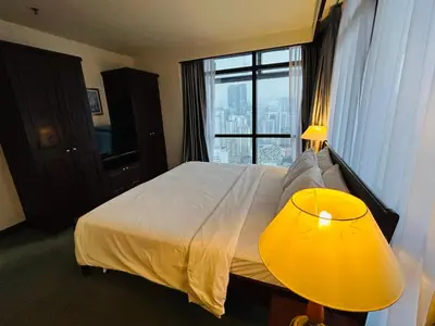 a hotel room with a bed and a large window at TWO BEDROOM SUITES at TIMES SQUARE KL in Kuala Lumpur