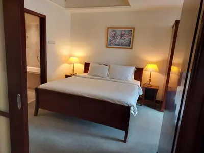 a bedroom with a large bed with two lamps at TWO BEDROOM SUITES at TIMES SQUARE KL in Kuala Lumpur