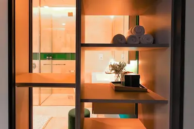 a room with a table and a mirror and a shelf at Tropicana The Residences - KLCC VIEW Luxury Apartment Collections in Kuala Lumpur
