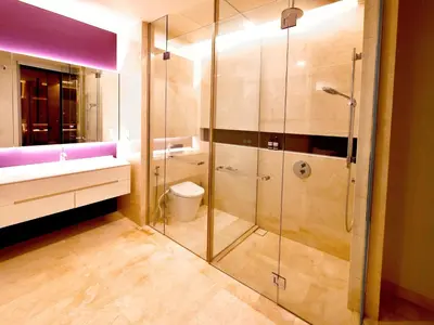 a bathroom with a glass shower and a sink at Tropicana The Residences - KLCC VIEW Luxury Apartment Collections in Kuala Lumpur