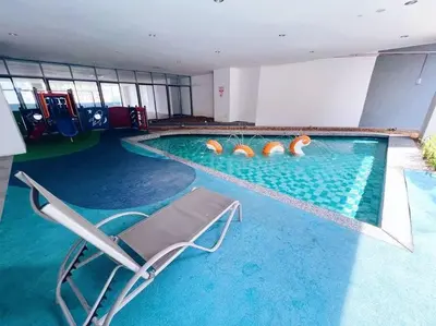 a swimming pool with a chair in the middle of it at PROMO Connected Train 2 Bedroom ABOVE MALL 289 in Kuala Lumpur