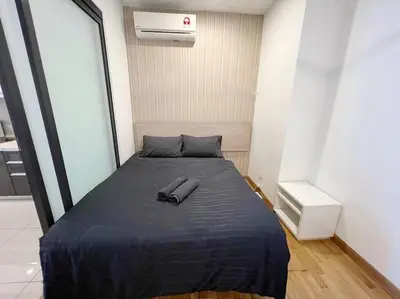 a bed in a small room with a pillow and a shoe on it at PROMO Connected Train 2 Bedroom ABOVE MALL 289 in Kuala Lumpur