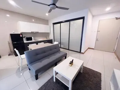 a living room with a blue couch and a table at PROMO Connected Train 2 Bedroom ABOVE MALL 289 in Kuala Lumpur
