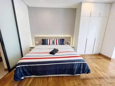 a bedroom with a bed with a backpack on it at PROMO Connected Train 2 Bedroom ABOVE MALL 289 in Kuala Lumpur