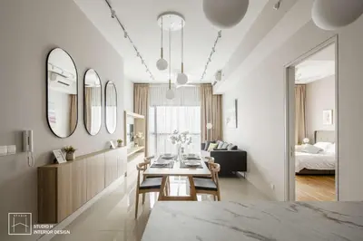 a dining room and living room with a table and mirrors at Royale KLCC in Kuala Lumpur