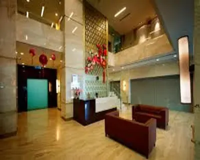 a lobby of a hotel with couches at Suasana Suites KLCC by Grand Royal in Kuala Lumpur