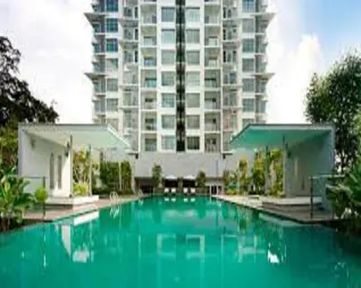 a large swimming pool in front of a large building at Suasana Suites KLCC by Grand Royal in Kuala Lumpur