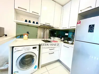 a kitchen with a washing machine and a refrigerator at Mercu Summer Suites in Kuala Lumpur