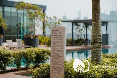 a sign in front of a building with a pool at Datum Jelatek by Plush in Kuala Lumpur