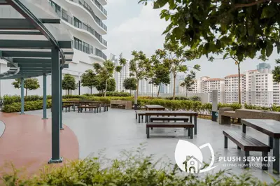 a park with benches and tables and buildings at Datum Jelatek by Plush in Kuala Lumpur
