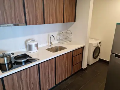 a small kitchen with a sink and a dishwasher at Una Residence by Maya in Kuala Lumpur