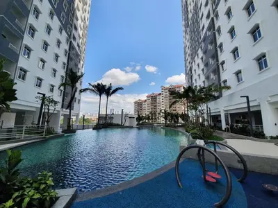 a swimming pool in the middle of two buildings at Bayu Andaman KL Centre in Kuala Lumpur
