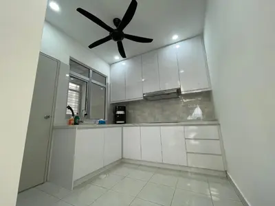 a kitchen with white cabinets and a ceiling fan at Bayu Andaman KL Centre in Kuala Lumpur