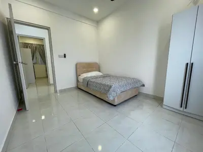 a bedroom with a bed in the corner of a room at Bayu Andaman KL Centre in Kuala Lumpur