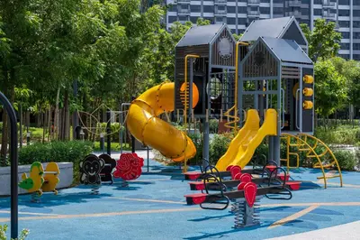 a playground with a yellow slide in a park at M Vertica Premier Suites Kuala Lumpur in Kuala Lumpur
