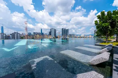 a swimming pool with a city skyline in the background at M Vertica Premier Suites Kuala Lumpur in Kuala Lumpur