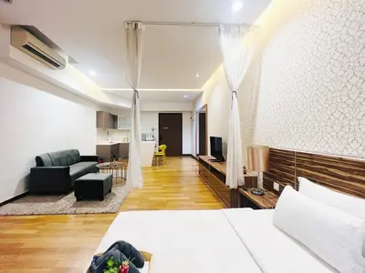 a bedroom with a bed and a living room with a couch at Awesomestay Apartment walk to PWTC near to KLCC in Kuala Lumpur