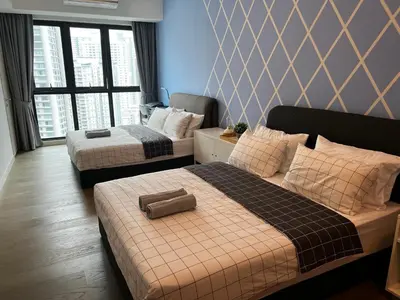 a hotel room with two beds and a large window at The Ooak Suite in Kuala Lumpur