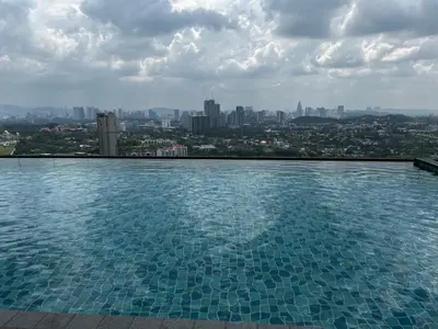 a swimming pool with a view of a city at The Ooak Suite in Kuala Lumpur