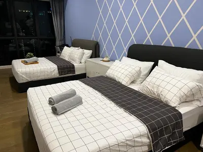two beds in a hotel room with two beds sidx sidx sidx at The Ooak Suite in Kuala Lumpur