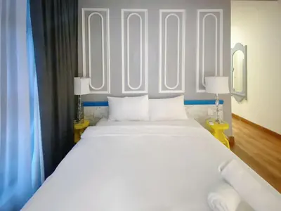 a large white bed in a room with two lamps at Arte Mont Kiara By Awesomestay in Kuala Lumpur