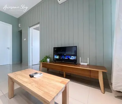 a living room with a tv and a wooden table at Arte Plus Ampang By Awesomestay in Kuala Lumpur