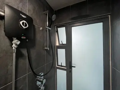 a bathroom with a shower with a door and a camera at The Colony By Infinitum By Awesomestay in Kuala Lumpur