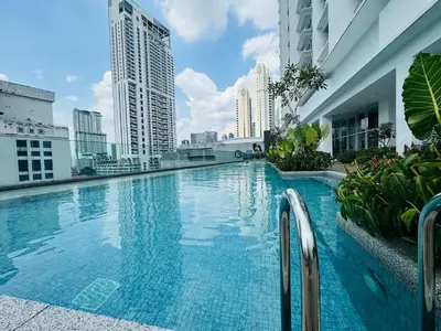 a swimming pool on the roof of a building with tall buildings at Quill Residences Kuala Lumpur in Kuala Lumpur