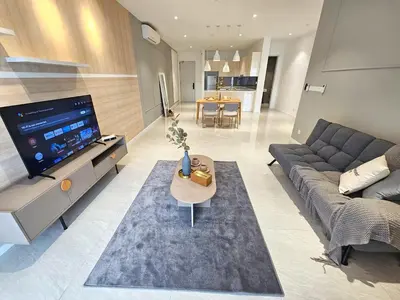 a living room with a couch and a tv at Quill Residences Kuala Lumpur in Kuala Lumpur