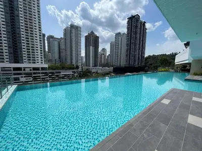 a large swimming pool in a city with tall buildings at Inspirasi Mont Kiara 3 Rooms Balcony Free WIFI & Carpark By The Homez in Kuala Lumpur