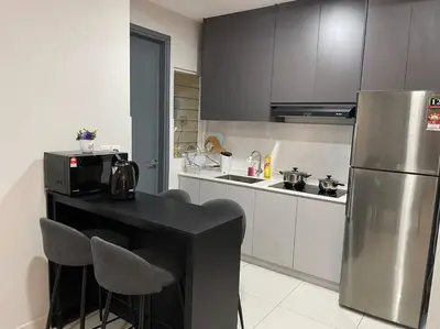 a kitchen with a black table and a refrigerator at Inspirasi Mont Kiara 3 Rooms Balcony Free WIFI & Carpark By The Homez in Kuala Lumpur