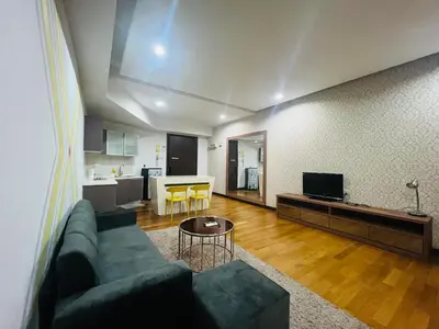 a living room with a couch and a table at Regalia Residence And Suites By The Relaxstay in Kuala Lumpur