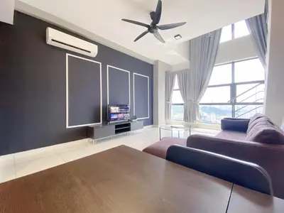 a living room with a couch and a tv at Arte Mont Kiara By The Relaxstay in Kuala Lumpur
