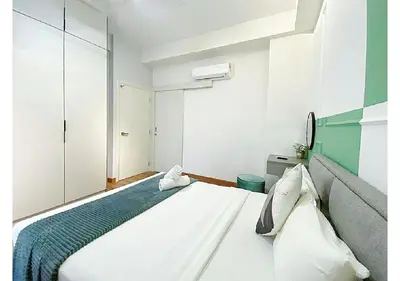 a bedroom with a large white bed in a room at Arte Mont Kiara By The Relaxstay in Kuala Lumpur