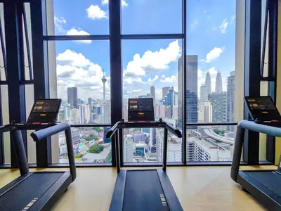 a gym with two treadmills and a view of the city at AXON Residence Kuala Lumpur in Kuala Lumpur