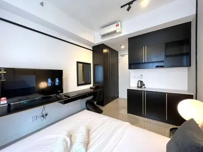 a bedroom with a bed and a tv in a room at AXON Residence Kuala Lumpur in Kuala Lumpur