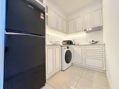 a kitchen with a black refrigerator and a dishwasher at AXON Residence Kuala Lumpur in Kuala Lumpur
