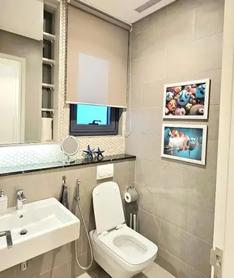a bathroom with a white toilet and a sink at Lucentia Residence Bukit Bintang in Kuala Lumpur