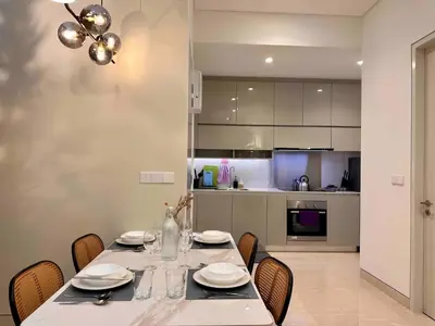 a dining room with a table and chairs and a kitchen at Lucentia Residence Bukit Bintang in Kuala Lumpur
