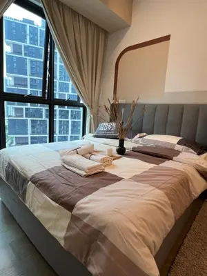 a large bed in a room with a large window at OOAK residence in Kuala Lumpur