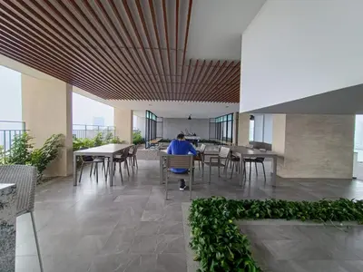 a person sitting in a chair in a room with tables at The Pano Jalan Ipoh Sentul by Kenangan Homes in Kuala Lumpur