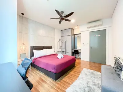 a bedroom with a bed and a ceiling fan at Mercu Summer Suites KLCC by Veedu Hauz in Kuala Lumpur