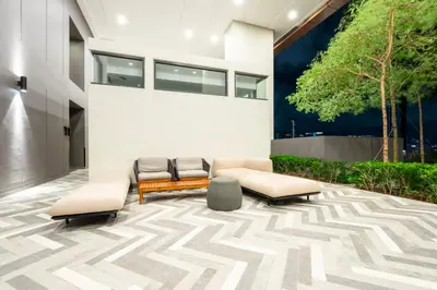 a lobby with three chairs and a building at Harmony Luxury Suites At Lucentia Bukit Bintang City Center in Kuala Lumpur
