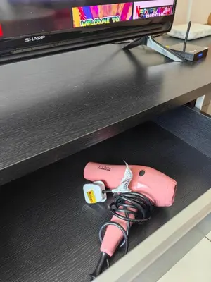 a pink nintendo wii game controller sitting on a shelf at 703 KLCC 5 minutes to Alor Street Ceylon Pavilion 3 Room Apt for 10 Pax in Kuala Lumpur